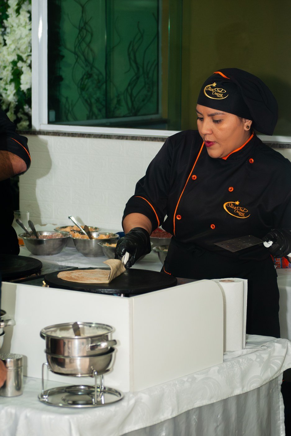 Chef do Buffet Star Crepes preparando crepe na chapa durante um evento